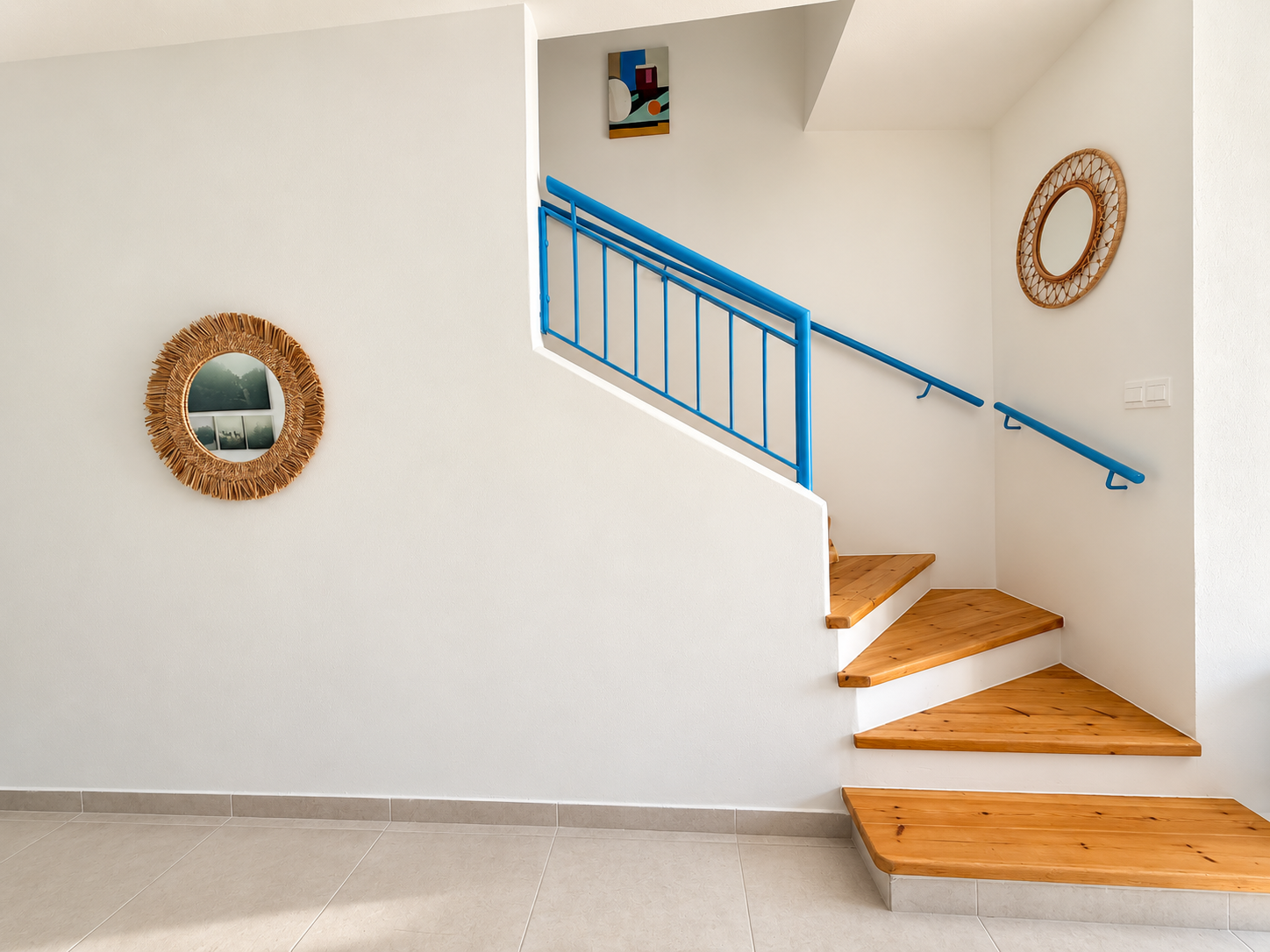 Wooden staircase with distinctive blue railing inside Paradise Gardens Villa 30