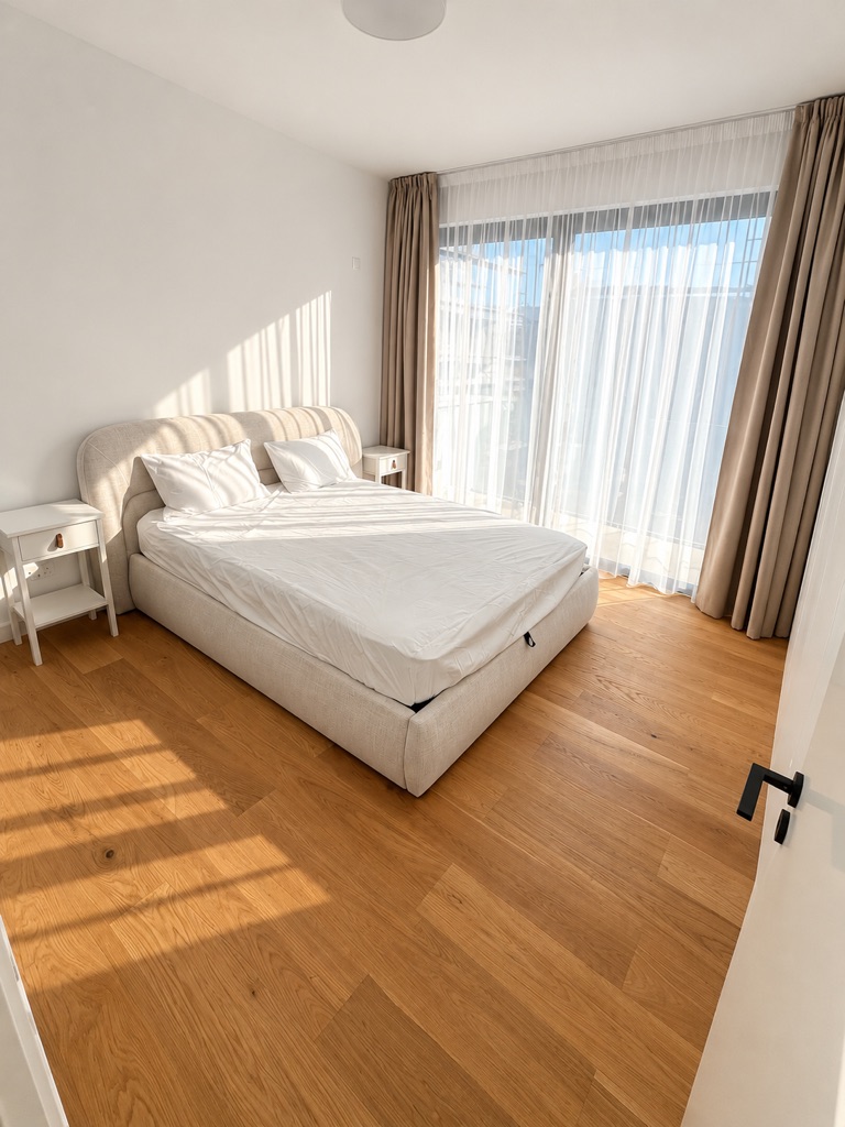 Bright bedroom with upholstered bed and large windows at Harmony Residence Villa 12