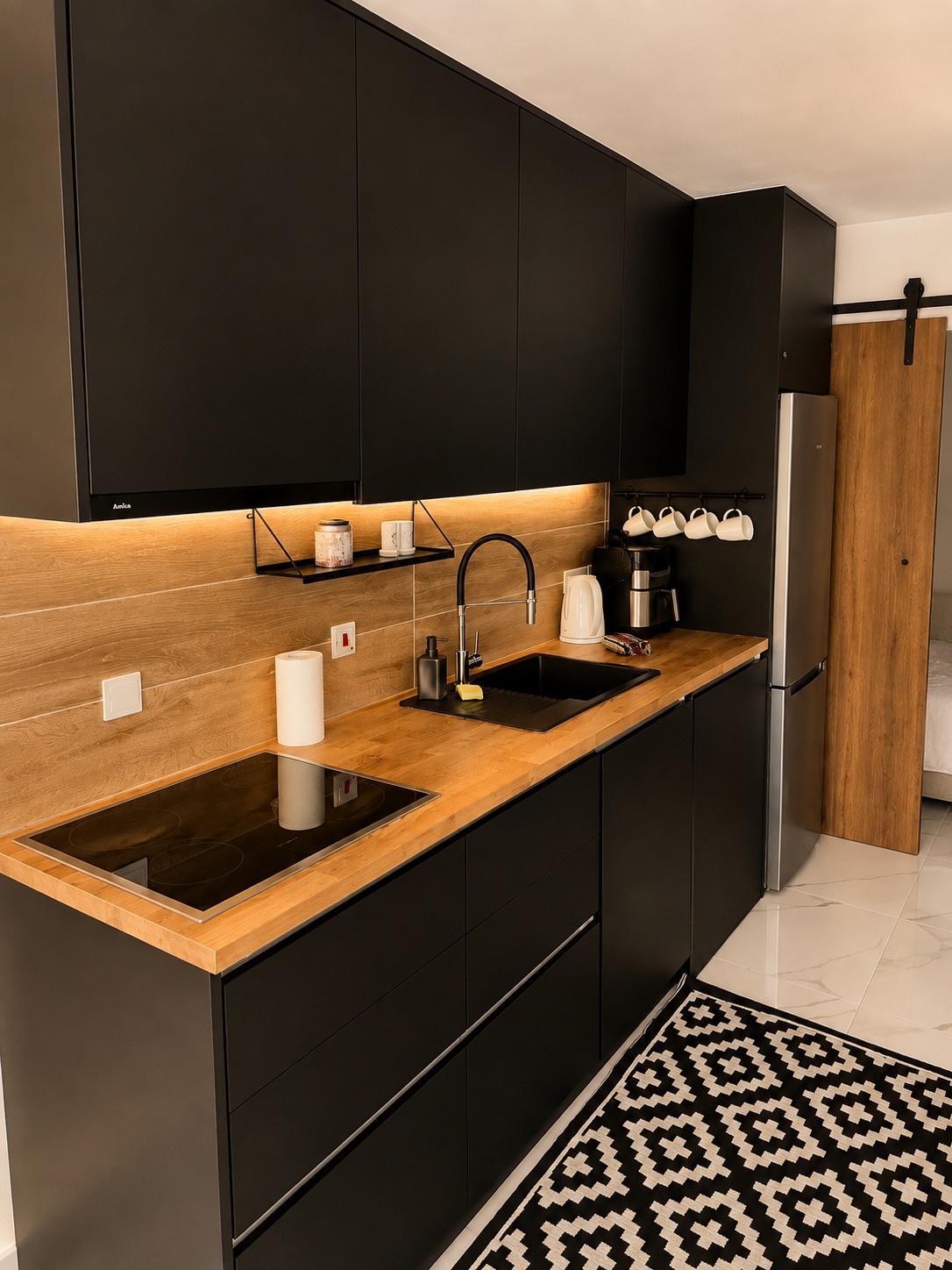 Fully equipped kitchen with black cabinetry at SeaGarden Hideaway