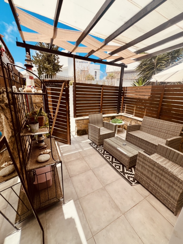 Sheltered private terrace with outdoor seating at SeaGarden Hideaway