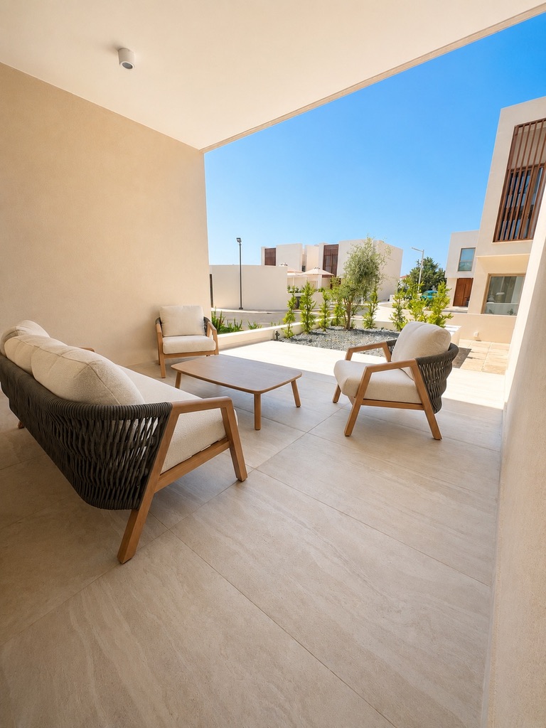 Outdoor sofa, armchairs and coffee table on the private terrace at Avalon Gardens A008