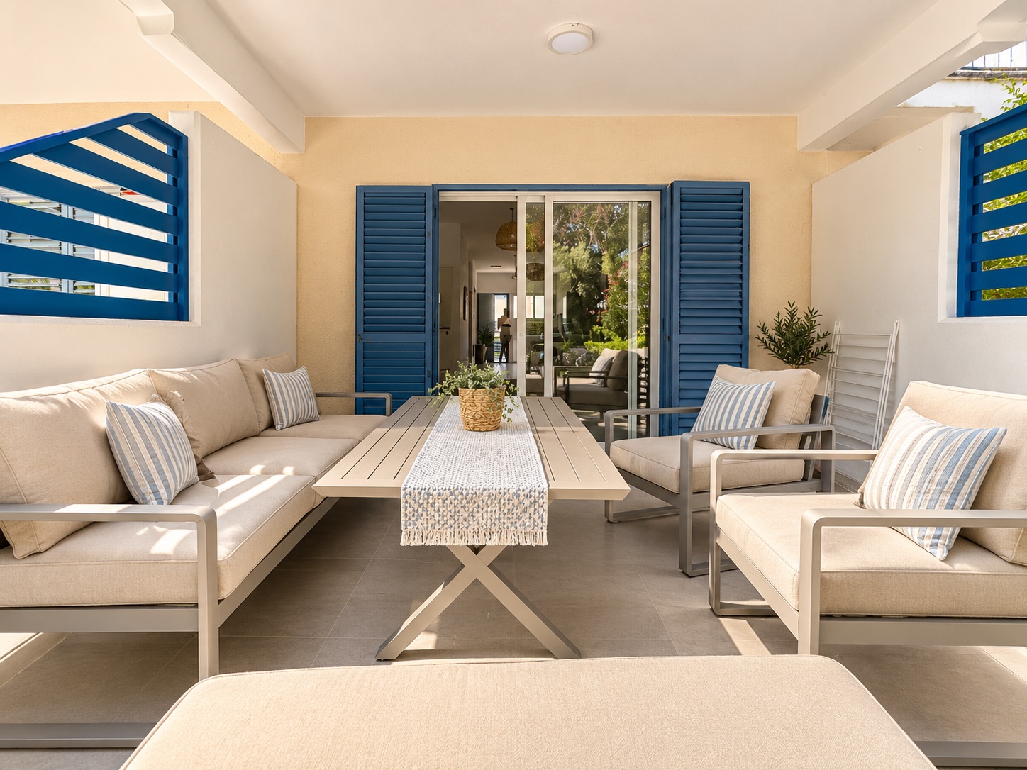 Private furnished terrace with outdoor seating and blue shutters at Paradise Gardens Villa 30