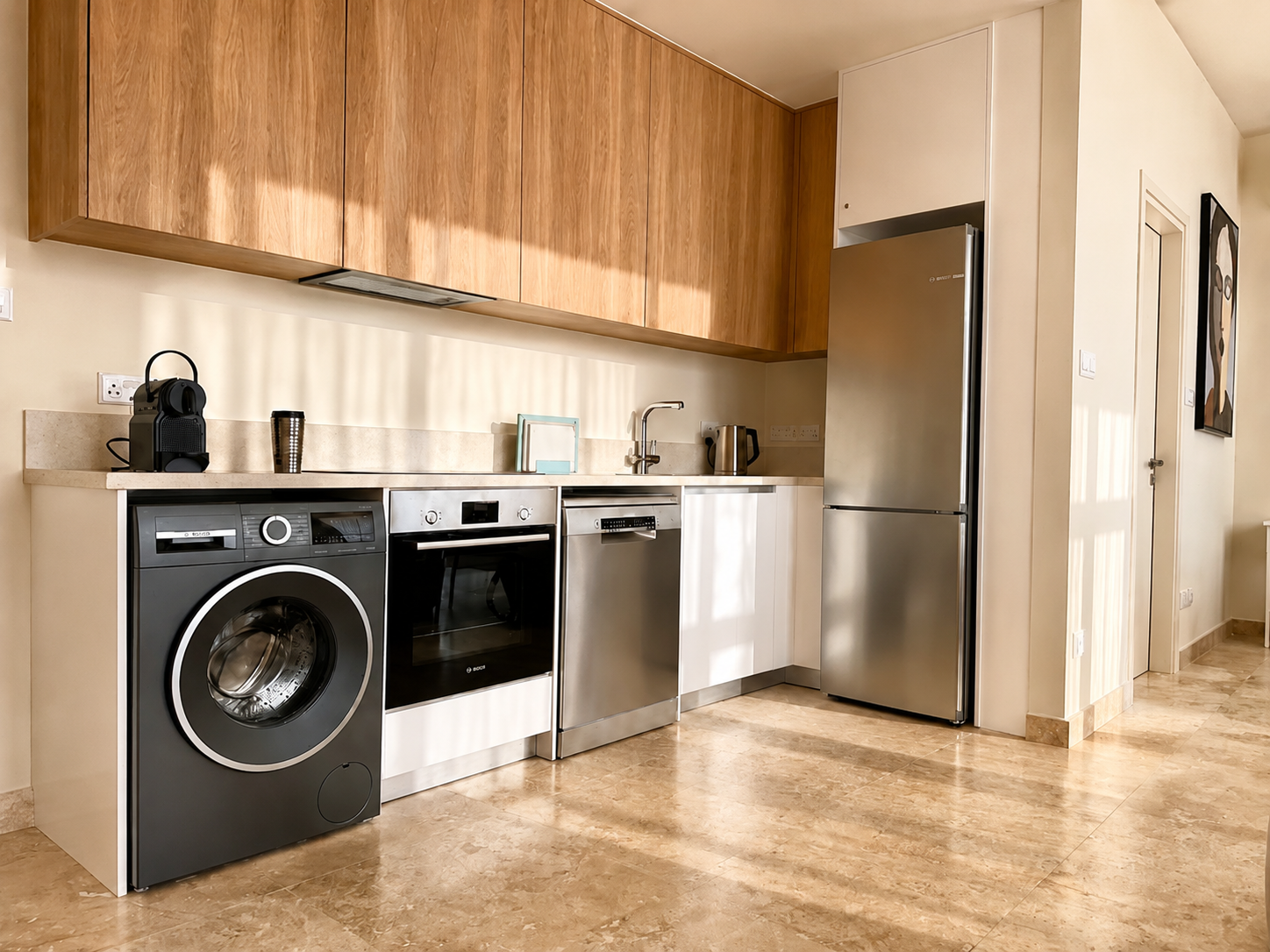 Fully equipped kitchen with washing machine and dishwasher at Avalon Gardens B101