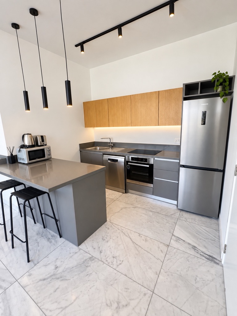 Fully equipped kitchen with island, dishwasher, oven, fridge and worktop at Stay City 301