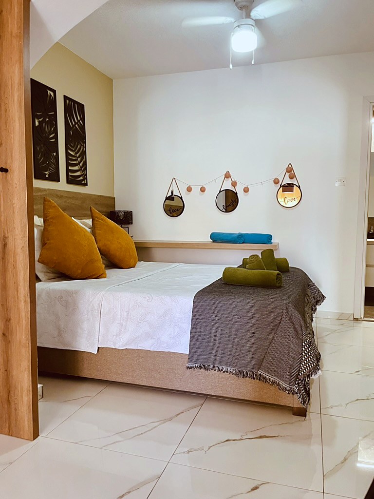 Bedroom with double bed and ceiling fan at SeaGarden Hideaway, Paphos