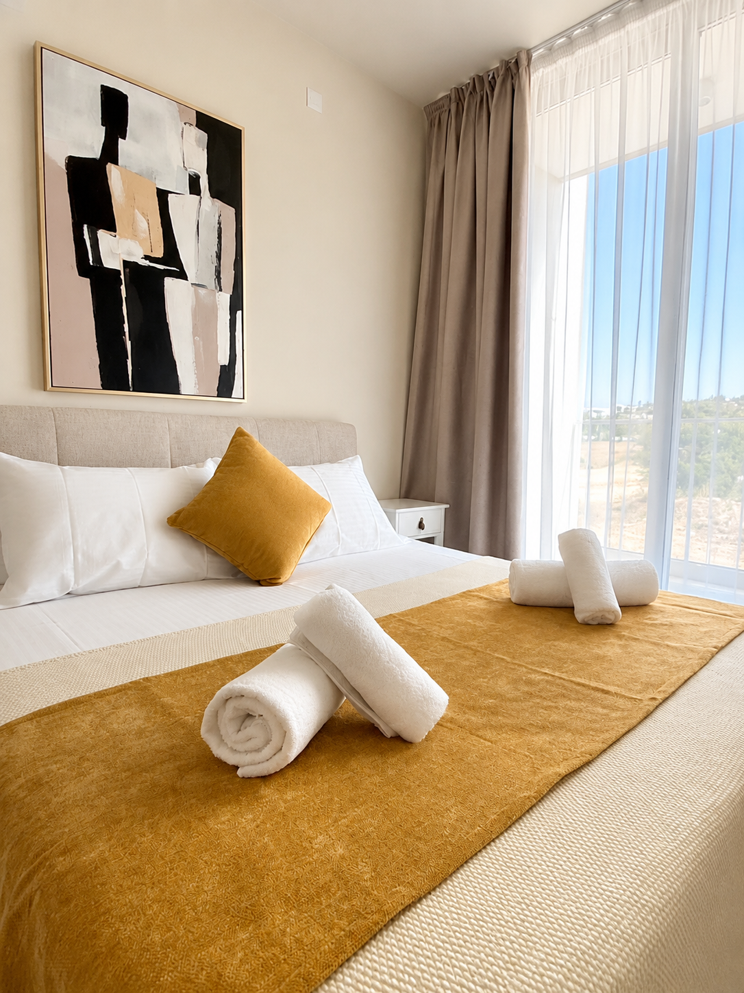 Queen bed with fresh linen at Avalon Gardens B101
