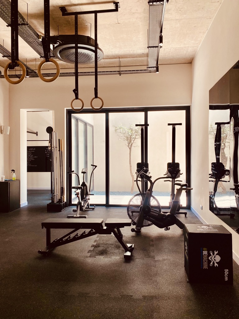 Indoor gym with free weights, benches and cardio equipment at Avalon Gardens