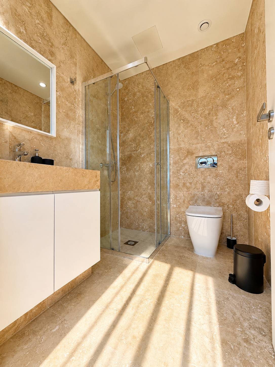 Modern bathroom with walk-in shower at Avalon Gardens A202