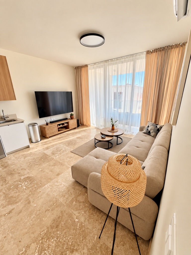 Representative living room with sofa and TV in an Avalon Gardens serviced apartment