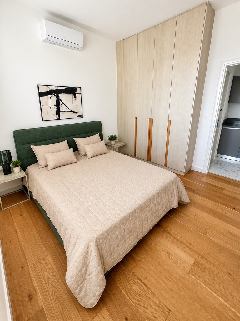 Bedroom with green upholstered headboard and full-height wardrobe at Stay City 301