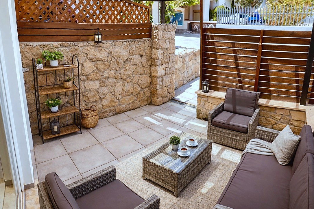 Private sheltered ground-floor terrace with outdoor seating at SeaGarden Hideaway