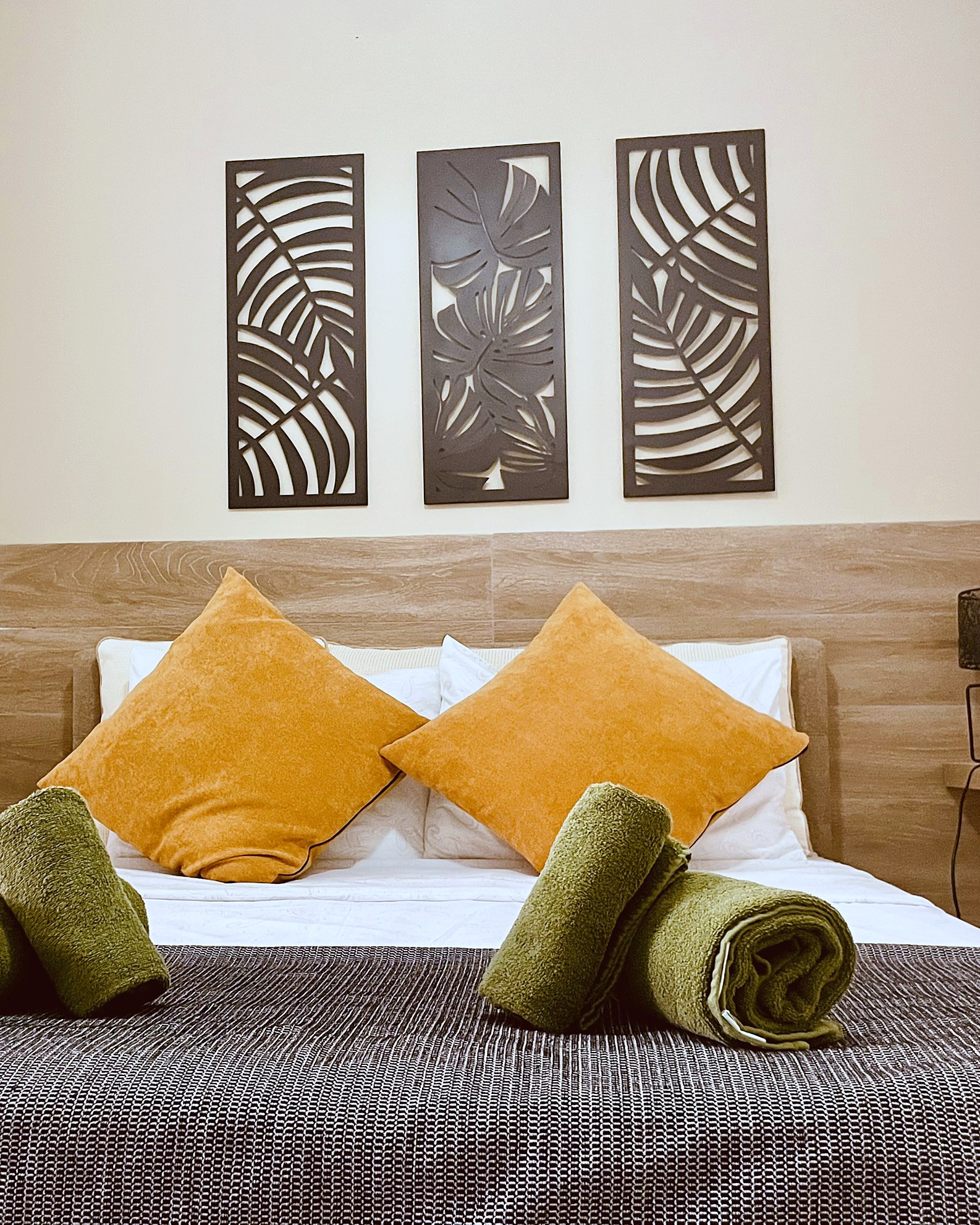 Bedroom detail with fresh linen and towels at SeaGarden Hideaway