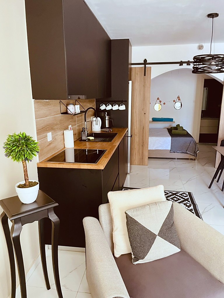 Fully equipped kitchen at SeaGarden Hideaway, a professionally managed apartment near Lighthouse Beach