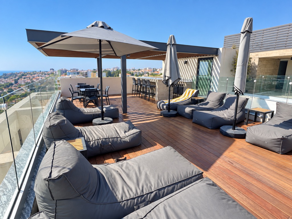 Rooftop terrace with loungers, umbrellas and Paphos views at Stay City 301
